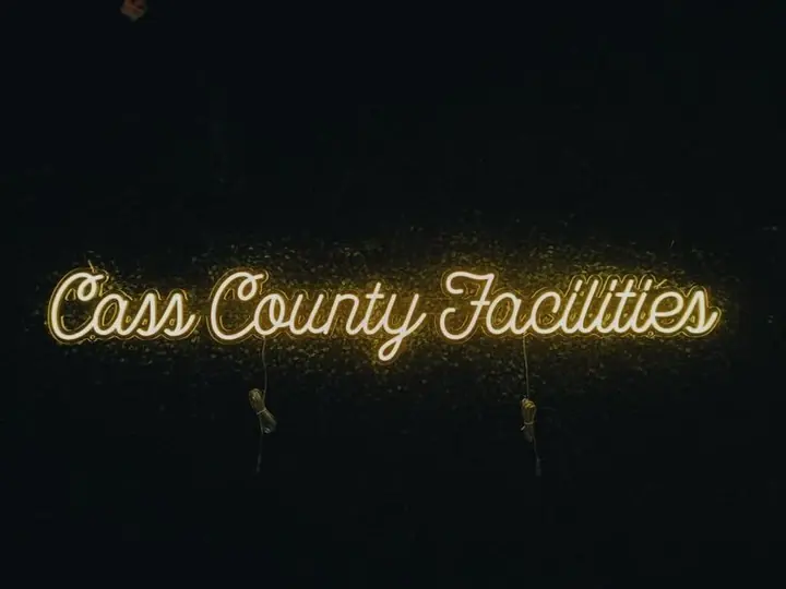 Cass County Facilities warm white script neon sign