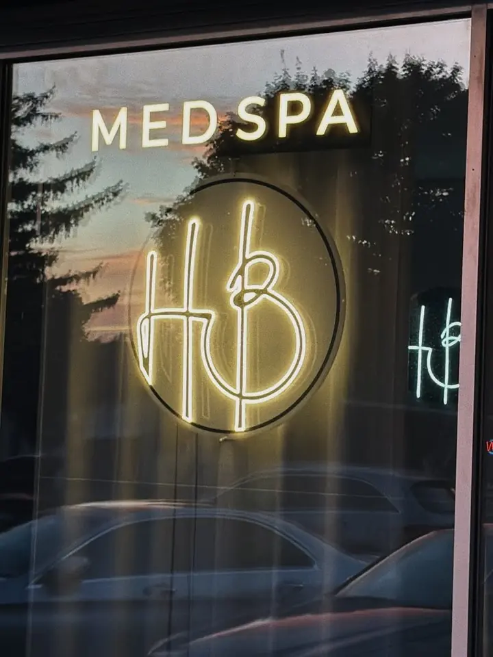 HB Med Spa LED neon logo in the storefront window