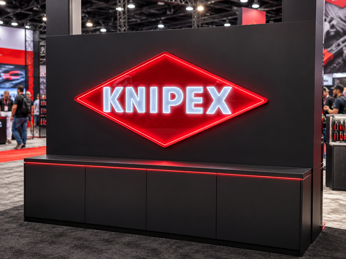 Large 84-inch-wide illuminated KNIPEX sign at the SEMA Show exhibit booth